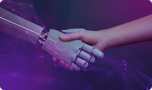 Human hand shaking a robotic hand, representing corporate AI training for enterprise teams